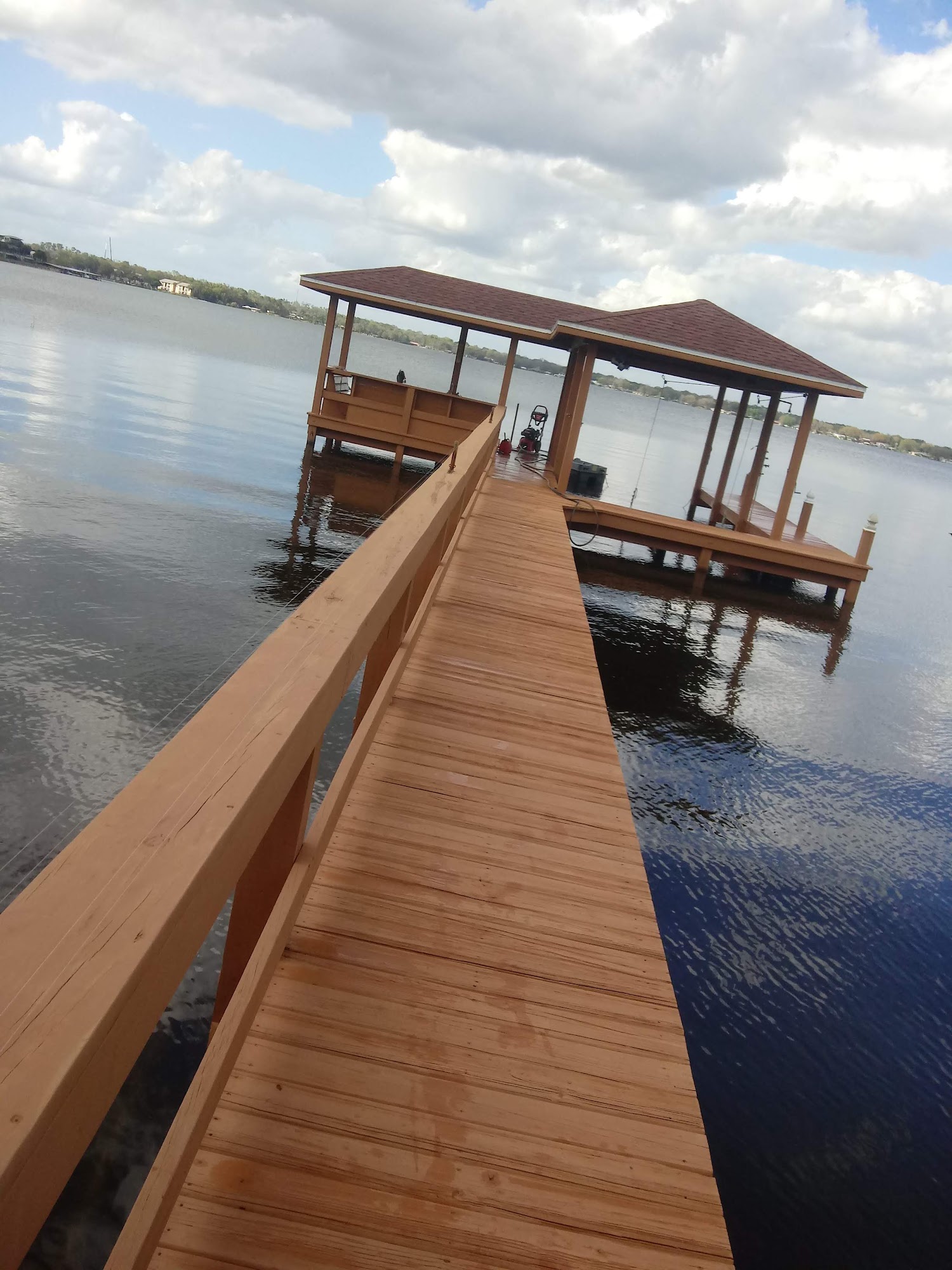 Finished dock walkway with stained wooden rails