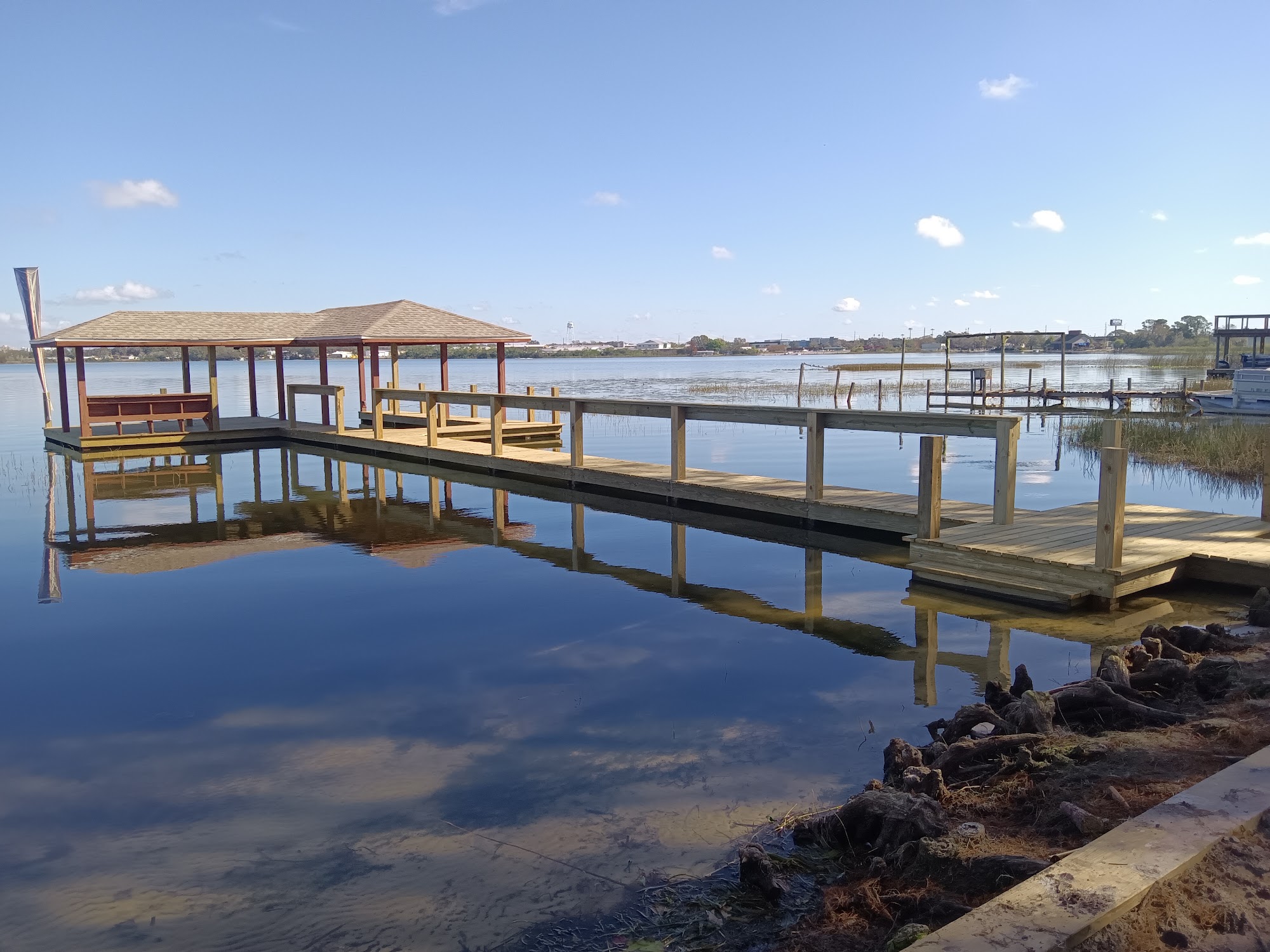 Finished dock with railings on calm water