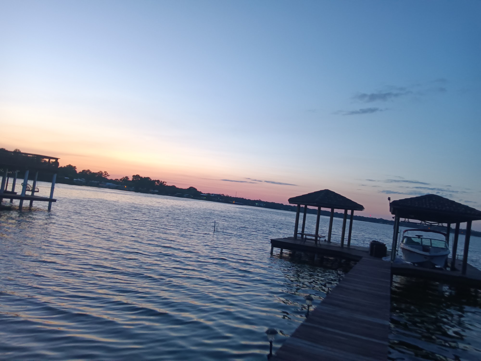 Long dock silhouetted at sunset